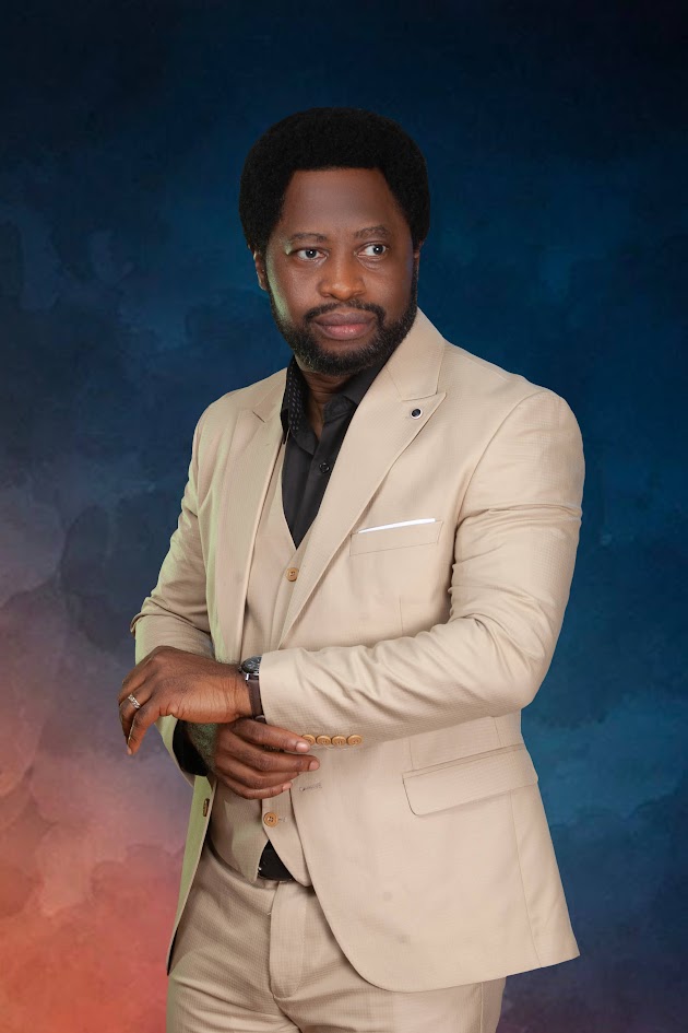 Ayo Oke in a beige three piece suit
