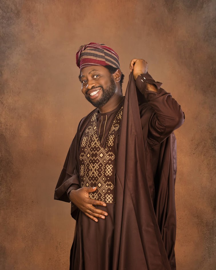 Ayo Oke in a brown embroidered agbada and cap